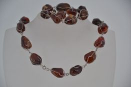 A vintage silver wire and carnelian necklace earring and bracelet set .