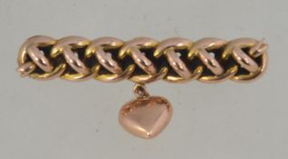 A hallmarked 9ct gold Victorian bar brooch pin fashioned with a rope twist and heart charm with C