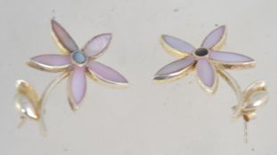 A silver and mother of pearl pair of flower drop earrings marked 925.