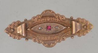 An Edwardian 9ct gold halmarked ruby brooch.