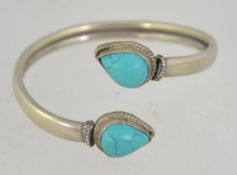 A vintage 20th century ladies silver and turquoise wrap bangle being marked 925 / 6cms diam