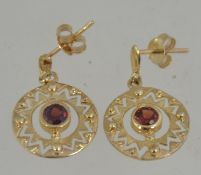 A pair of 9ct gold and uby garnet stone earrings complete with posts, the drops of roundel form.
