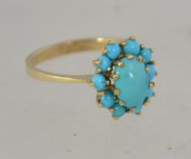 A 14ct gold turquoise cluster ring. Size N.5. Weight 2.8g. Marked 14ct tests 14ct gold.