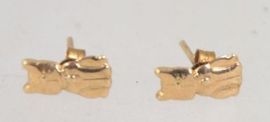 A 9ct gold stud earrings set in the form of comical cats. Marked 9ct. Weight .