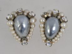 A pair of white metal rhinestone and pearl clip on earrings with ornate fiigree clips.