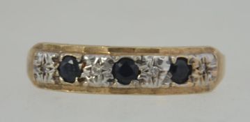 A 9ct gold sapphire and diamond ring. The Diamonds approx 4pnts surrounded 3 5pnt sapphires.