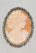 A 1930's shell cameo and marcasite brooch, unmarked but tests as silver with roll over catch. 3.