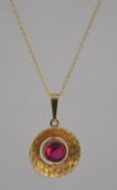 A vintage modernist rolled gold pendant necklace the pendant being set with a red stone within a