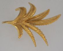 A vintage Sphinx gold tone brooch in the form of a fern with roller clasp. Signed Sphinx.