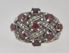 A large silver, garnet and marcasite cocktail ring beng marked 925. Weight 92.