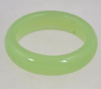A heavy vintage Chinese pale green jade bangle.