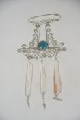 A 1980's loug pin brooch with natural quartz crystal pendant drops with white metal,