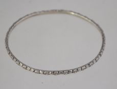 A silver 1950's ladies bangle bracelet with illusion spacer design with scratch carved decoration.