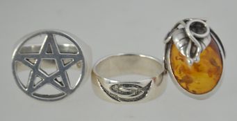 3 silver rings to include a cabochon amber ring with silver leaf mount,
