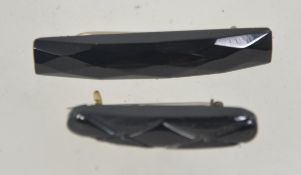 Two Victorian Whitby Jet brooches of lozenge form with gilt white metal pins and loop clasps. 4.