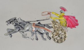 A vintage 1950's silver tone and enamel figural brooch pin of a Roman driving a horse drawn chariot