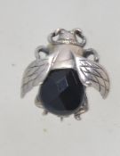 A vintage white metal bug brooch with faceted french jet abdomen and roller clasp. Measures 2cms.