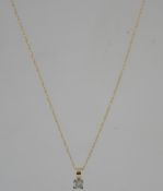 A 9ct gold diamond pendant necklace strung with a princess cut solitaire diamond in a prong setting