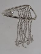 A 1960's / 1970's large modernist brooch with chain frings having silver tone with roll over clasp.
