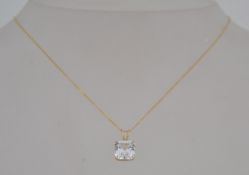 A 14k and 9ct pendant necklace strung with marked 14k pendant set with princess cut gem stone on a