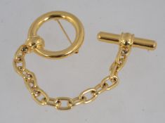 A vintage signed Monet gold tone double pin brooch with two roller clasps. Measures 13.5cms.