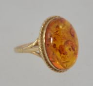 A 9ct gold and cabochon cut amber set dress ring of large form. The ring size R/ Weight 3.