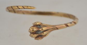 A vintage yellow metal lions paw wrap around bangle