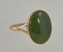 A 9ct gold 1930s Art Deco ring set with a Jade cabochon with split shoulders. Size O. Weight 3.1g.