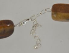 A vintage tigers eye agate necklace with silver 925 clasp having lobster claw clasp.