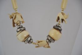 A 1930's Ivory and silver bead necklace with ball ivory and silver spacers having elephant figural