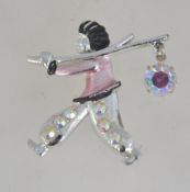 A 1950's silver tone enamel figural brooch pin set with aurora Borealis rhinestones of a figure