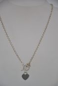 A silver bead / ball necklace and pendant chain with heart pendant.