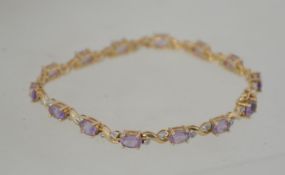 A 9ct gold, diamond and amethyst ladies bracelet.
