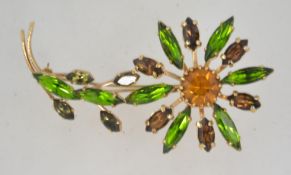A large 1960's rhinestone flower brooch having claw set marquise rhinestones in a gold tone setting.