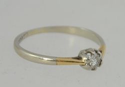 A 18ct white and yellow gold solitaire diamond ring. Diamond approx 7pts. Marked 18ct Star.