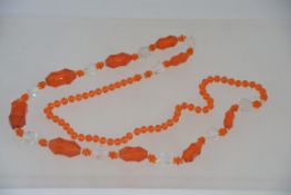 A 1920's Czech / continental string of flappa beads in bright orange glass being recently re-strung