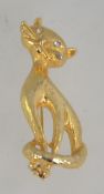 A vintage god tone figural brooch of a cat with clear rhnestone set eyes and roller clasp.