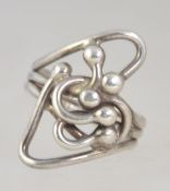 A modernist style ring of silver construction bearing London hallmarks.