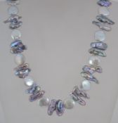 A vintage baroque freshwater pearl necklace having large white and grey pearls with gold tone and