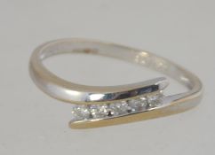 A 9ct white gold and diamond contemporary suspension 5 stone channel set ring.