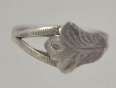 A silver ring with crossover acanthus leaf motif. Tests silver.