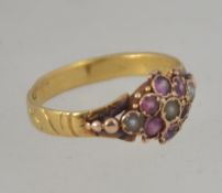 A Victorian 18ct gold amethyst ladies ring. The head inset with seed pearls surrounded by amethysts.