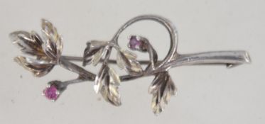 A vintage 1960's / 1970's silver brooh set with two small rubies. Marked silver having loop clasp.
