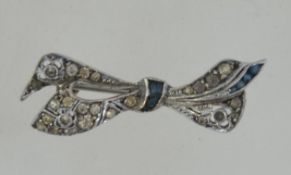 A silver and marcasite brooch in the form of a bow . Pin verso.