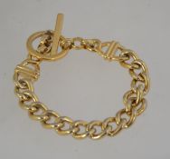 A vintage signed gold tone chain link bracelet signed Monet with toggle clasp. Measures 7.5 inches.