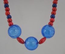 An early 1980's chunky wood and plastic bead statement necklace in red and blue with block