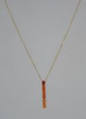 A 9ct gold necklace and articulated garnet adorned pendant.