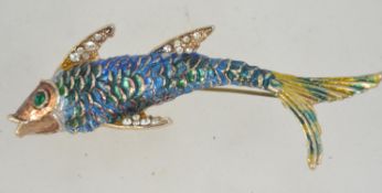 A 1960's enamel and rhinestone brooch in the form of a fish having a gold tone setting with