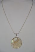 A silver 925 snakelinked necklace chain with mother of pearl inset carved pendant in the form of
