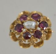 A Victorian 18ct gold cluster brooch pin set with central pearl surrounded by 6 garnets with c